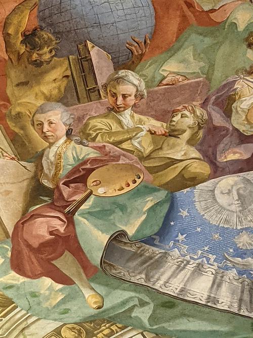 Mögliches Selbstporträt Johann Wenzel Bergl als Maler mit Farbenpalette, links. Detail aus Deckenfresko im Augustiner-Lesesaal der ÖNB, 1773-75 Mögliches Selbstporträt Johann Wenzel Bergl als Maler mit Farbenpalette, links. Detail aus Deckenfresko im Augustiner-Lesesaal der ÖNB, 1773-75