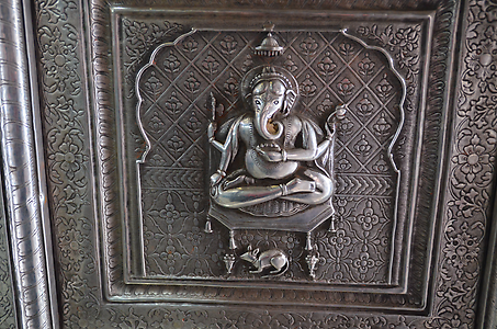 God Ganesha as son of Shiva is accompanied by a rat and rides on it God Ganesha as son of Shiva is accompanied by a rat and rides on it