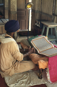 Reading from the holy book Guru Granth Sahib at many places in the area of the Temple Reading from the holy book Guru Granth Sahib at many places in the area of the Temple