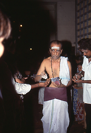Another servant distributes sacred ash, consisting of burnt offerings Another servant distributes sacred ash, consisting of burnt offerings