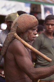Dani man with stone axe Dani man with stone axe